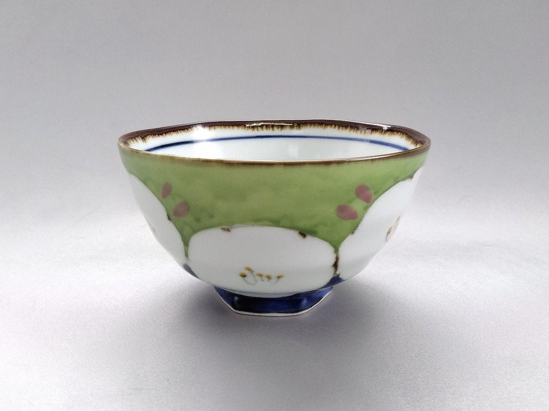 A green hexagonal porcelain rice bowl with a dark flower pattern