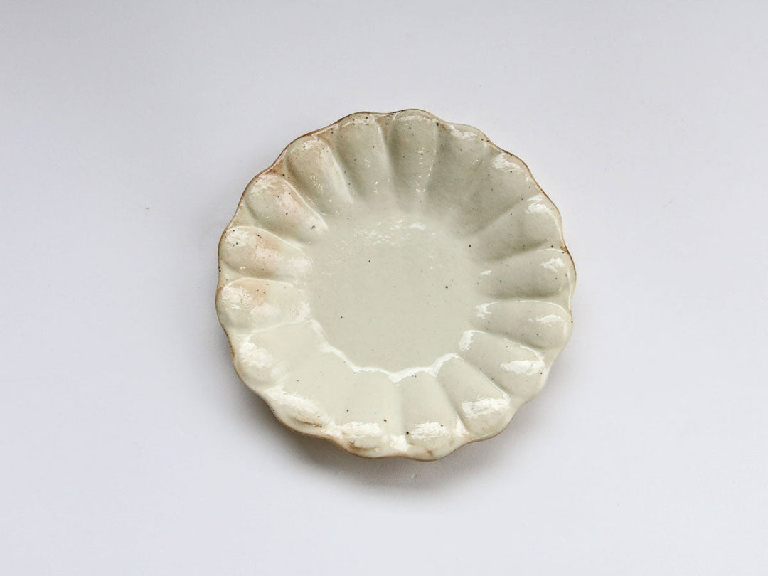 A small deep plate with a lobed edge and an iron-speckled glaze