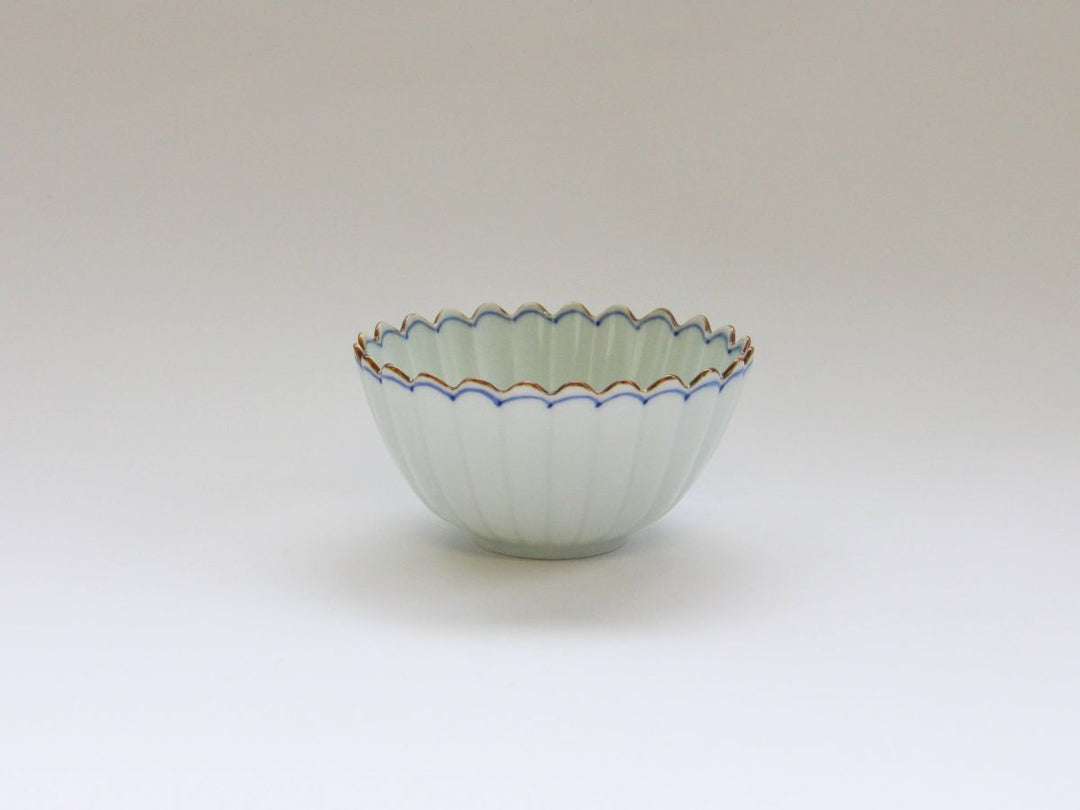 A small oval bowl with a chrysanthemum shape and a rust-accented rim line