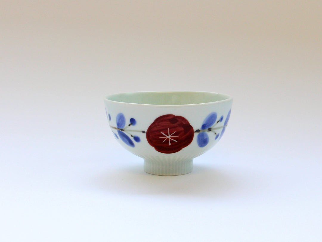 A blue and white mini rice bowl with a red floral pattern