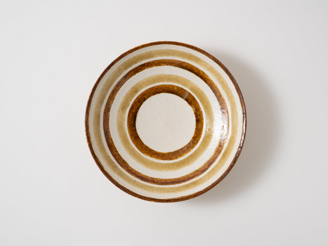 An amber yellow plate with a ring line around the well
