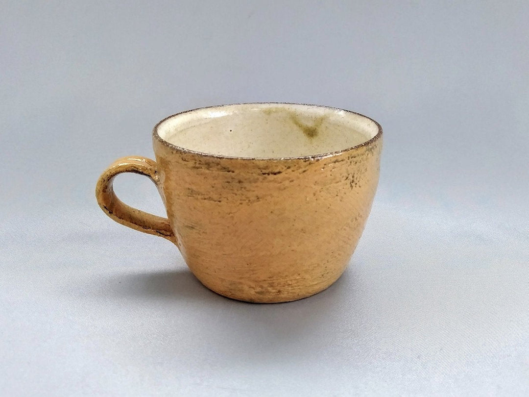 A yellow painted slip mug by Takuya Ohara
